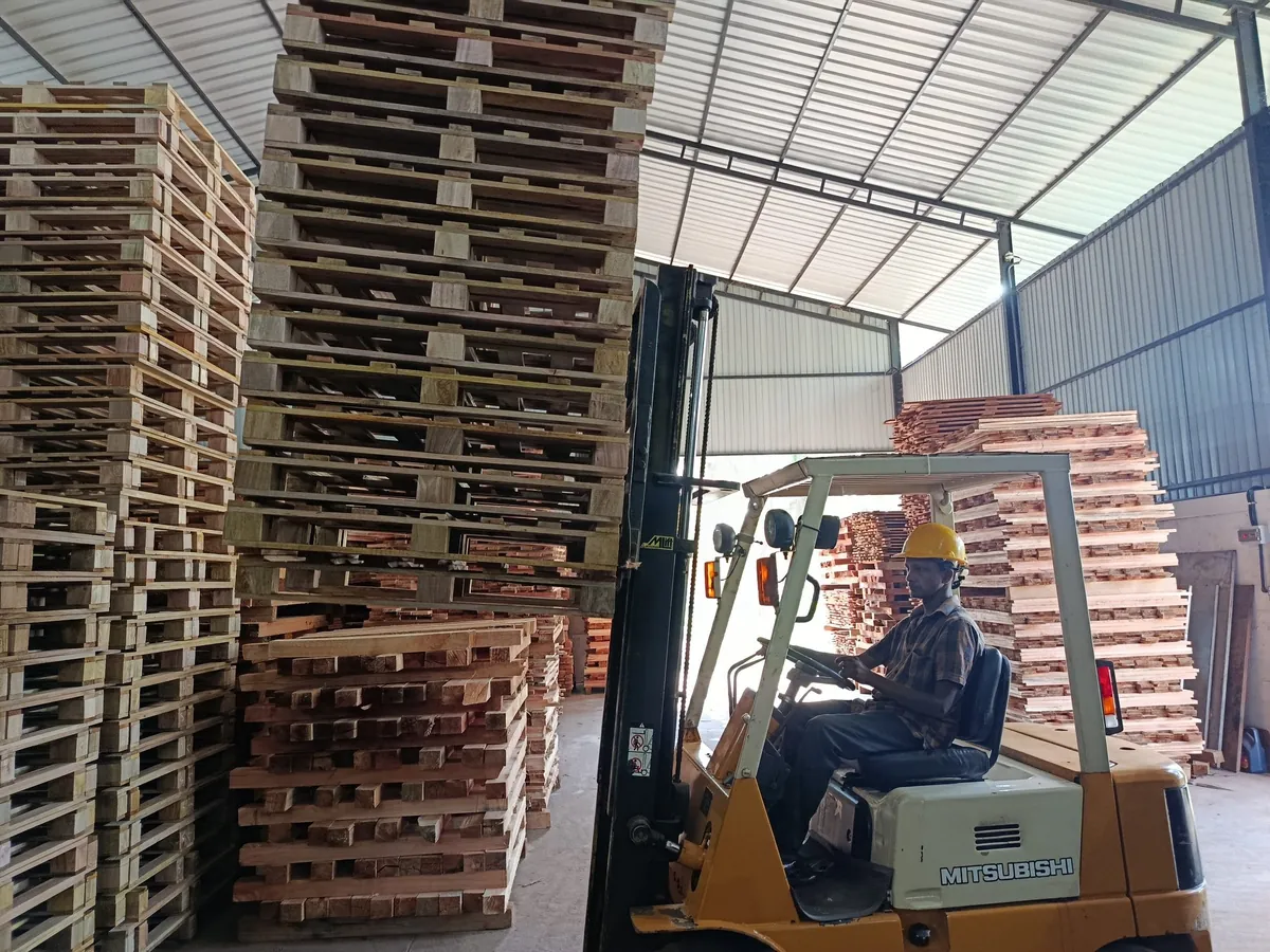 Forklift loading wooden pallets at Dissanayake Enterprises pallet manufacturing